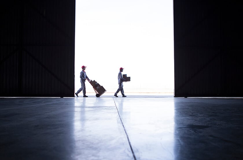 two people at a distance moving boxes two people at a distance moving boxes